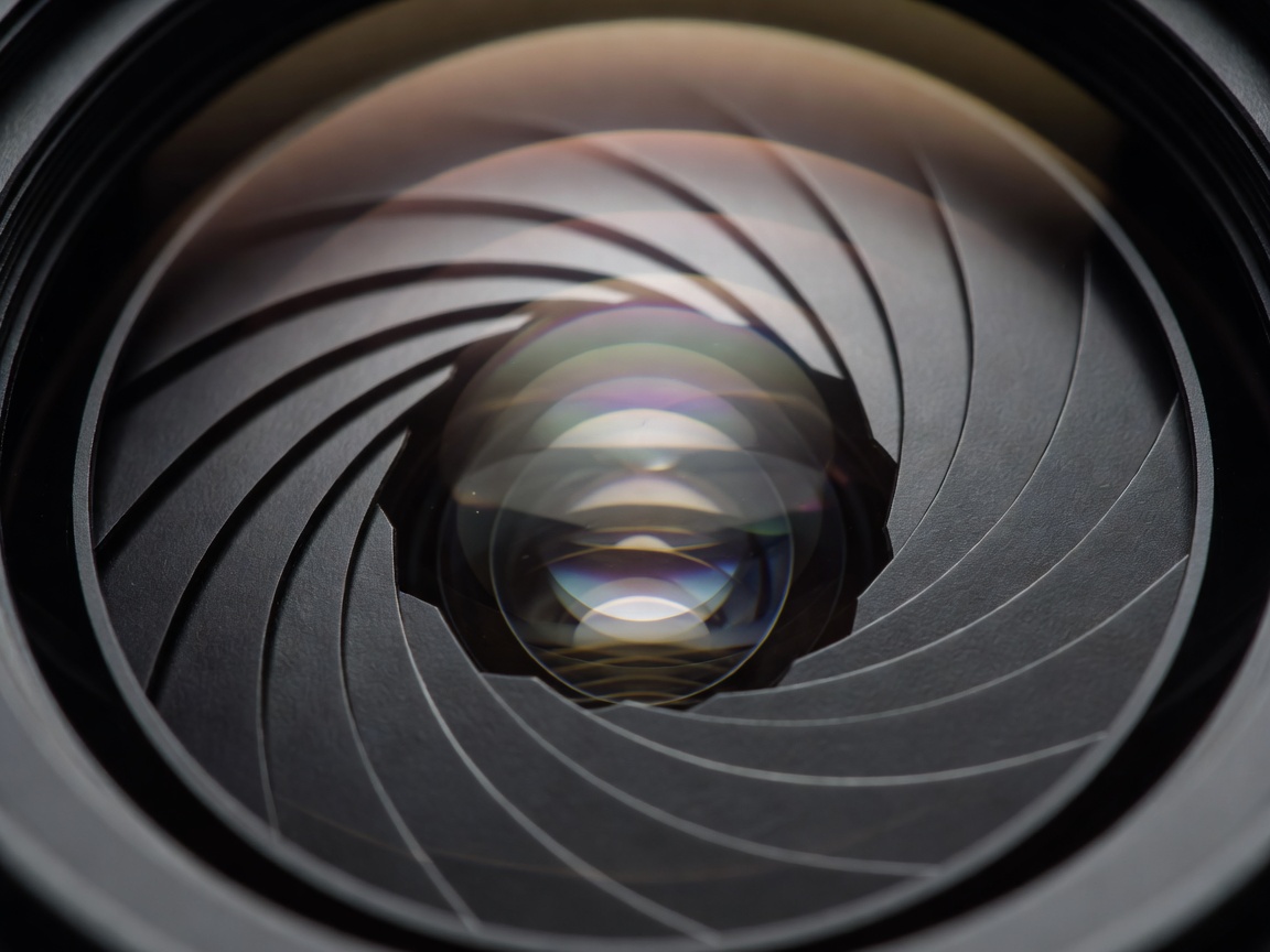 Detailed close-up of camera lens mechanical aperture blades with anti-reflective glass coating